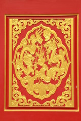 Fototapeta na wymiar Golden dragon decorated on red wood