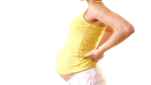 Pregnant woman toching her back