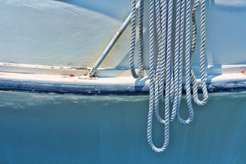 White worn rope hanging from boat