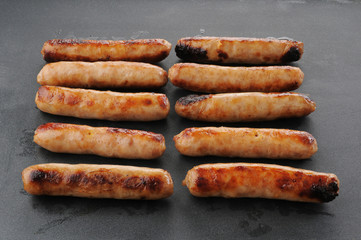 Link Sausage cooking on a griddle