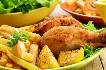 Fried drumsticks with french fries