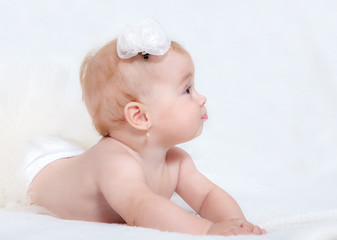 Portrait newborn baby lying in bed