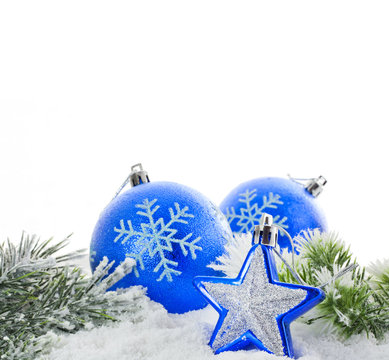 Christmas blue baubles and snowflakes on white background
