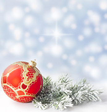 Christmas branch of tree red bauble snow background