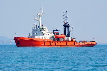 Fototapeta premium Orange rescue fire tow in the sea on anchor parking