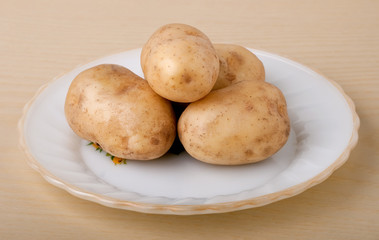 Fresh potatoes on a white plate