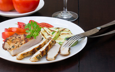 Pork steak with grilled zucchini and tomato salad