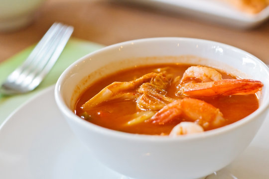 Thai spicy soup on white cup (Kaeng Som with shrimp).