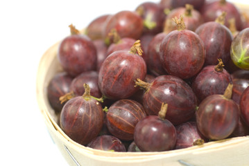 Red gooseberries in a wicker basket.