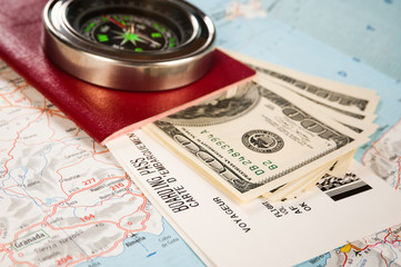 compass, money and passport with boarding pass