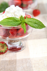 Strawberries with whipped cream and mint