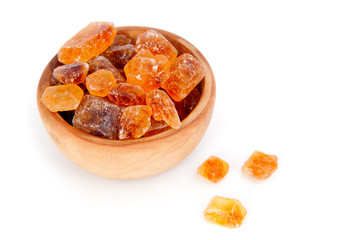 brown sugar in wooden bowl,  over a white background.