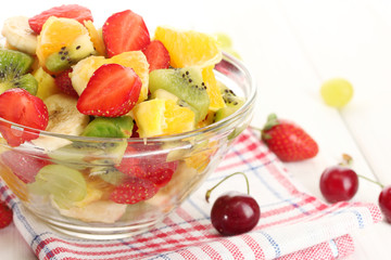 glass bowl with  fresh fruits salad and berries