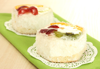 sweet cake with fruits on wooden table