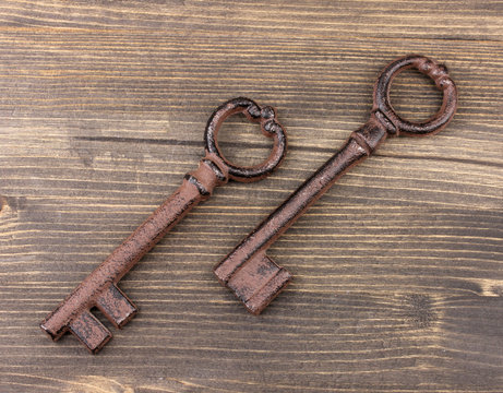 Two antique key on wooden background