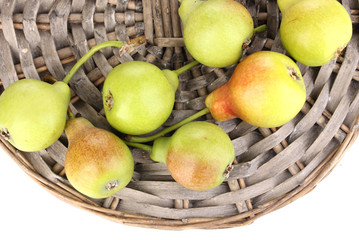 ripe pears on wicker mat isolated on white.