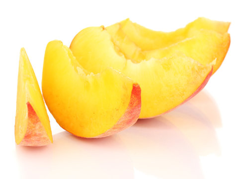 ripe peach slices isolated on white.