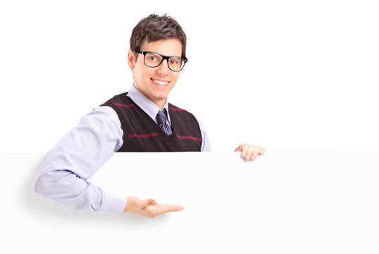 A smiling handsome guy gesturing on a white panel