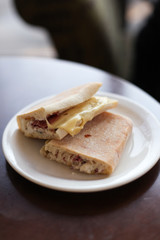 Two ham and cheese sandwiches on a plate