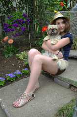 A young woman with dog smiling into the camera