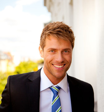 good looking business man smiles
