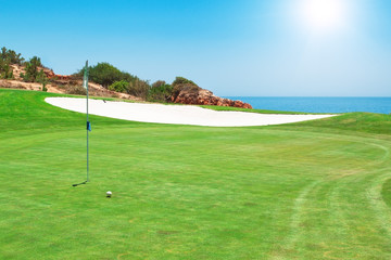 Golf course on the background of the sea. Summer.