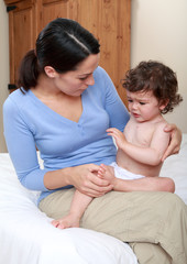 Mum comforting crying baby