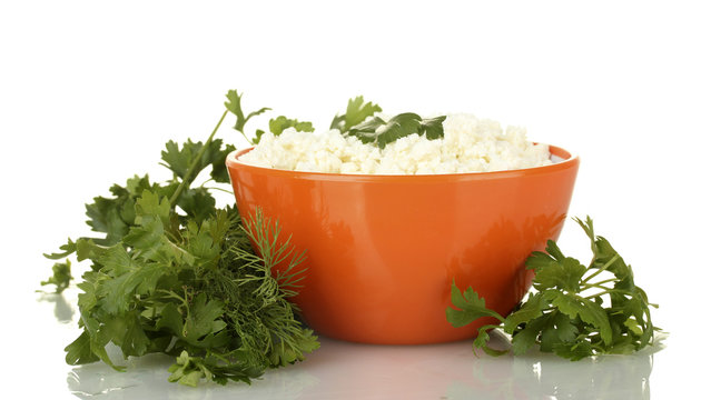 cottage cheese with parsley and dill in orange bowl isolated