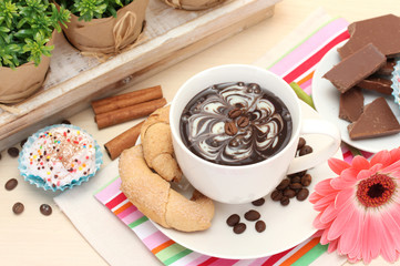 cup of coffee and gerbera  beans, cinnamon sticks