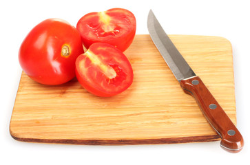Ripe red tomatoes and knife on cutting board isolated on white