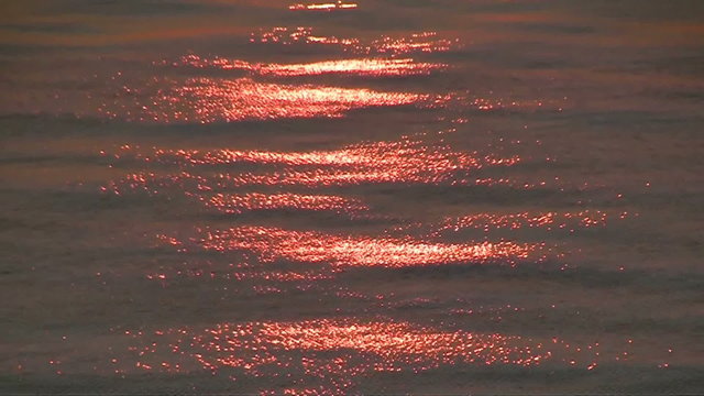 Reflection of sunset sun on sea