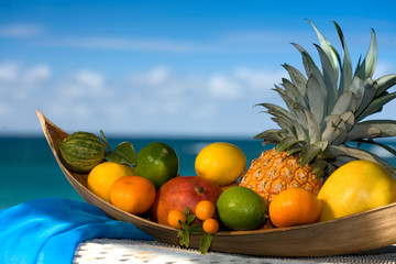 Tropical fruit basket , sea  on the background