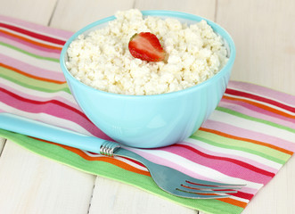 cottage cheese with strawberry in blue bowl and fork