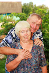 Smiling senior couple embracing outdoors