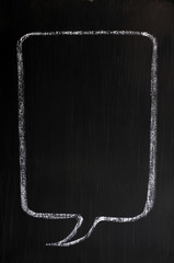 Blank speech bubble drawn on a smudged blackboard