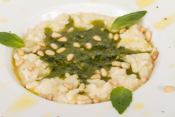 photo of delicious risotto dish with herbs and cedar nut on whit