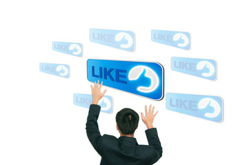 Business man catching like button on the screen background