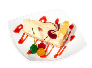 Closeup of a slice of cherry cheesecake on a white background