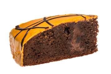 Piece of chocolate cake with icing on white isolated background