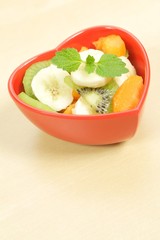 fruity salad in heart shaped bowl