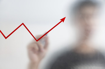 Businessman drawing on a glass screen
