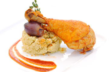 prepared drumstick with onion and cereals on white plate