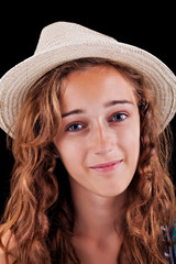 Beautiful teenage girl with brown hair and modern beige hat