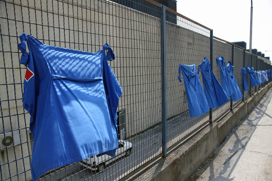 blue shirts stretched out into the net during a strike of worker