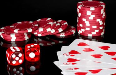flush with poker chips and dice on black background