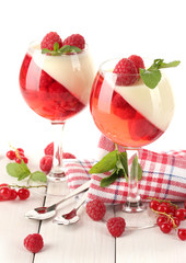 fruit jelly with berries in glasses on wooden table