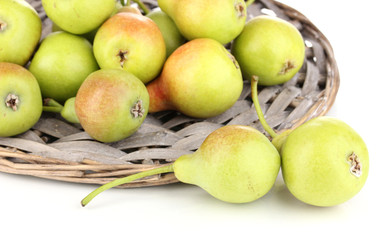 ripe pears on wicker mat isolated on white.