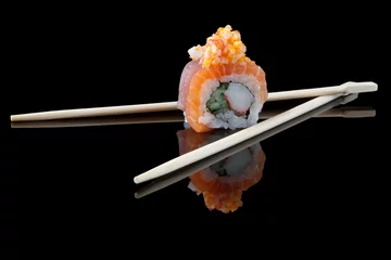 Fotobehang sushi with chopsticks over black background © Mariusz Blach