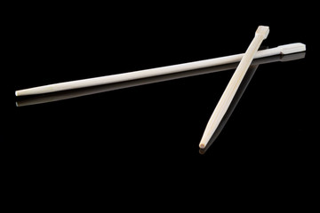 chopsticks over black background