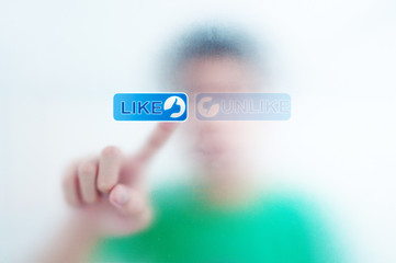 finger pressing Social Network icon on like button